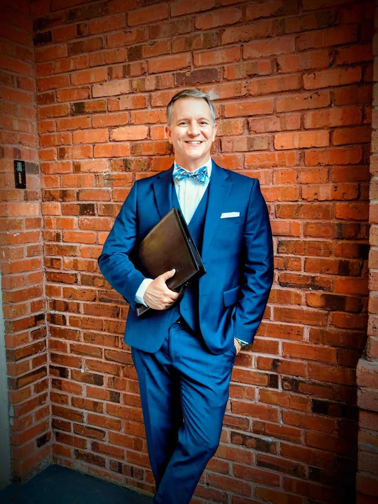 Guy is posing at the Historic Venue 1902 in Sanford, Florida after a lovely wedding ceremony