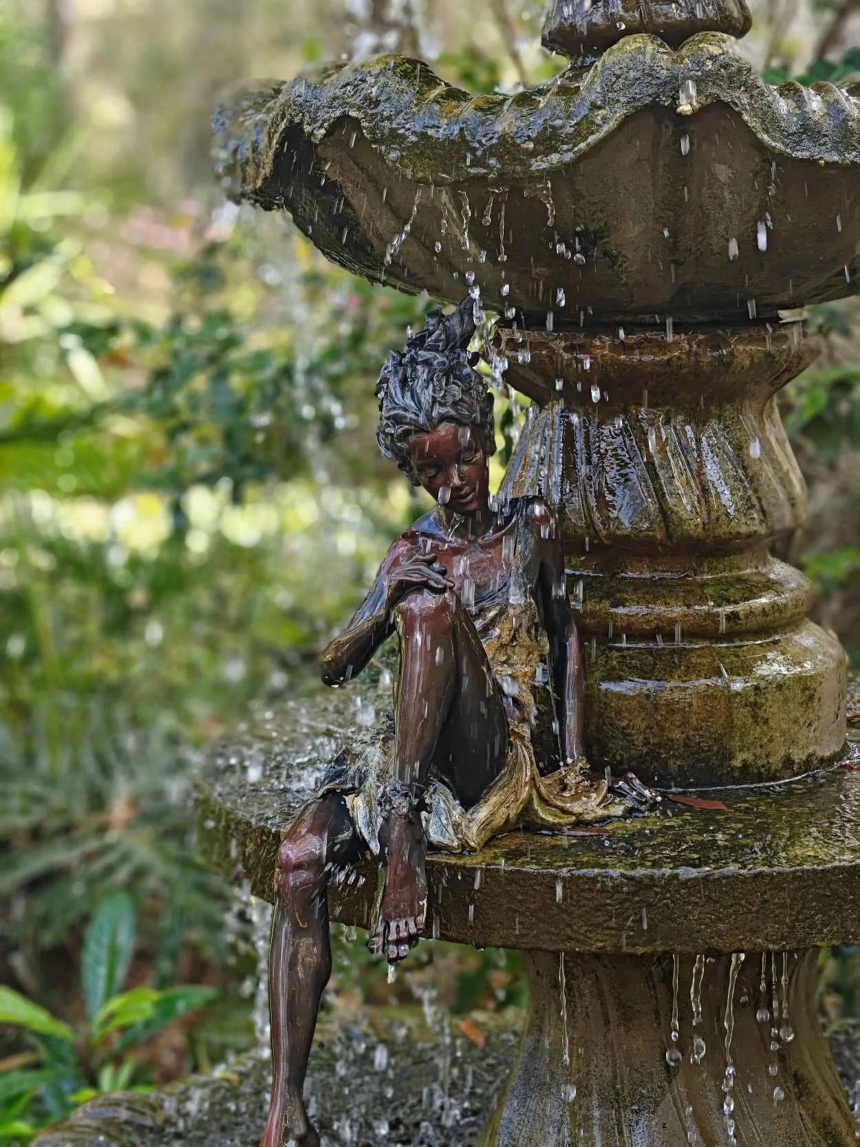 A water nymph at harmony gardens is enjoying a splash on a hot day