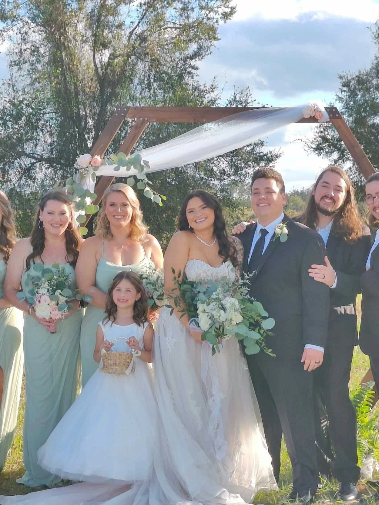 All smiles as a beautiful couple and family celebrate right after their wedding ceremony