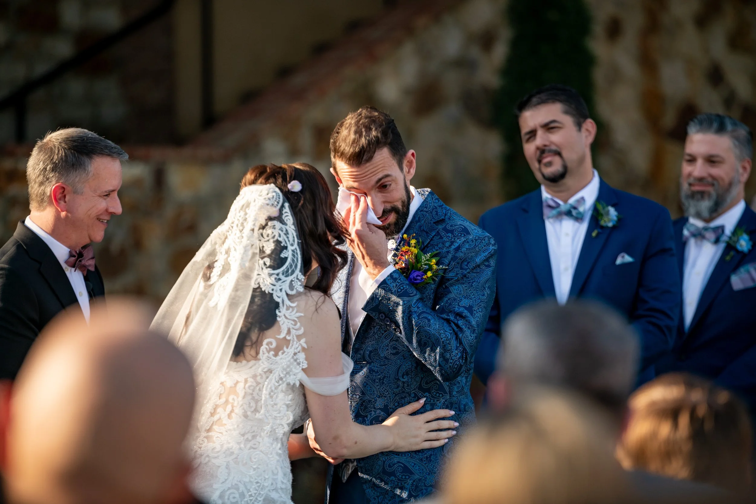 Wedding officiant Guy Thee Wed performing a heartfelt ceremony at Bella Collina in Montverde, Florida, as the groom wipes away tears during the custom couple's story.