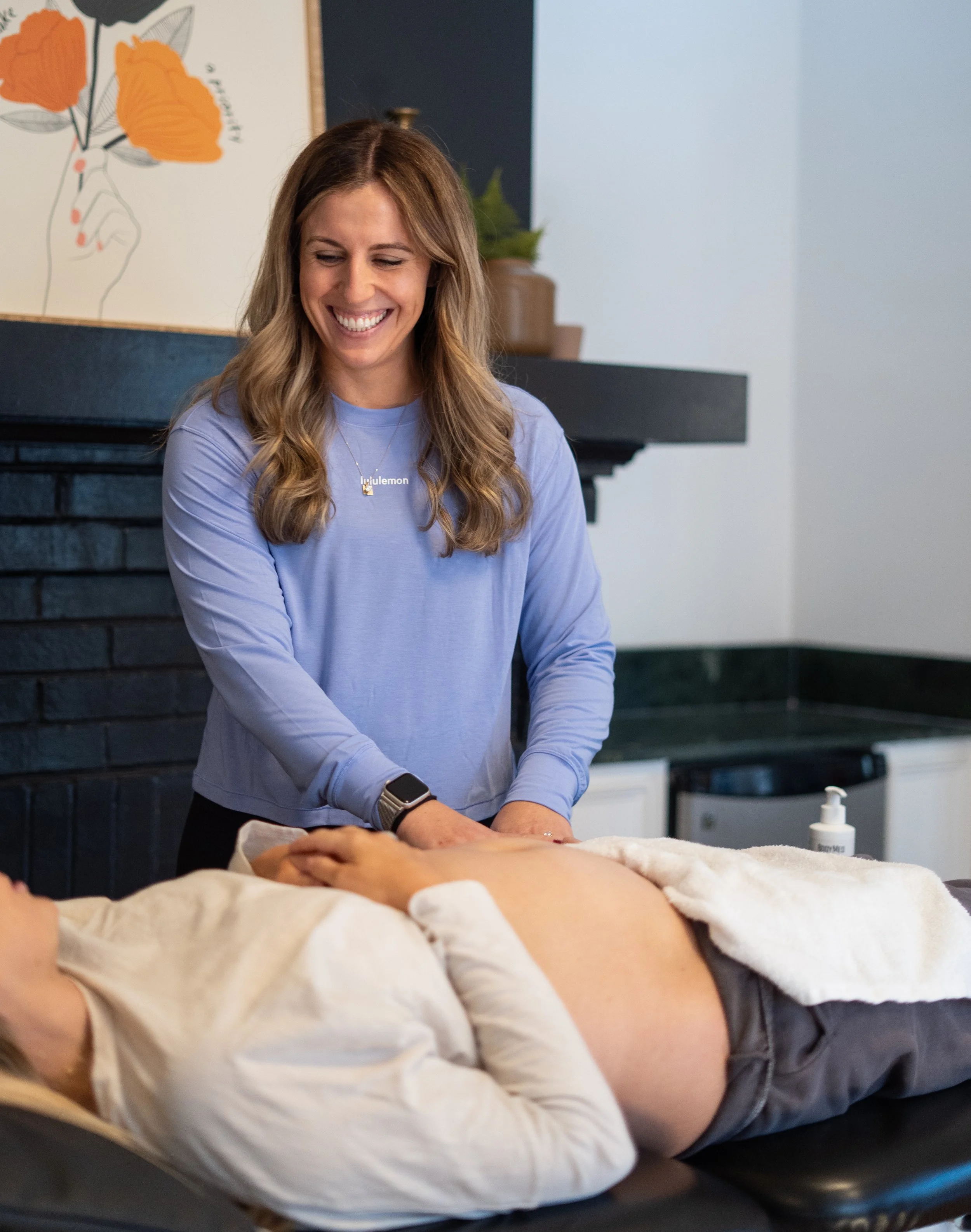 pelvic floor physical therapist performing c-section scar massage on a patient