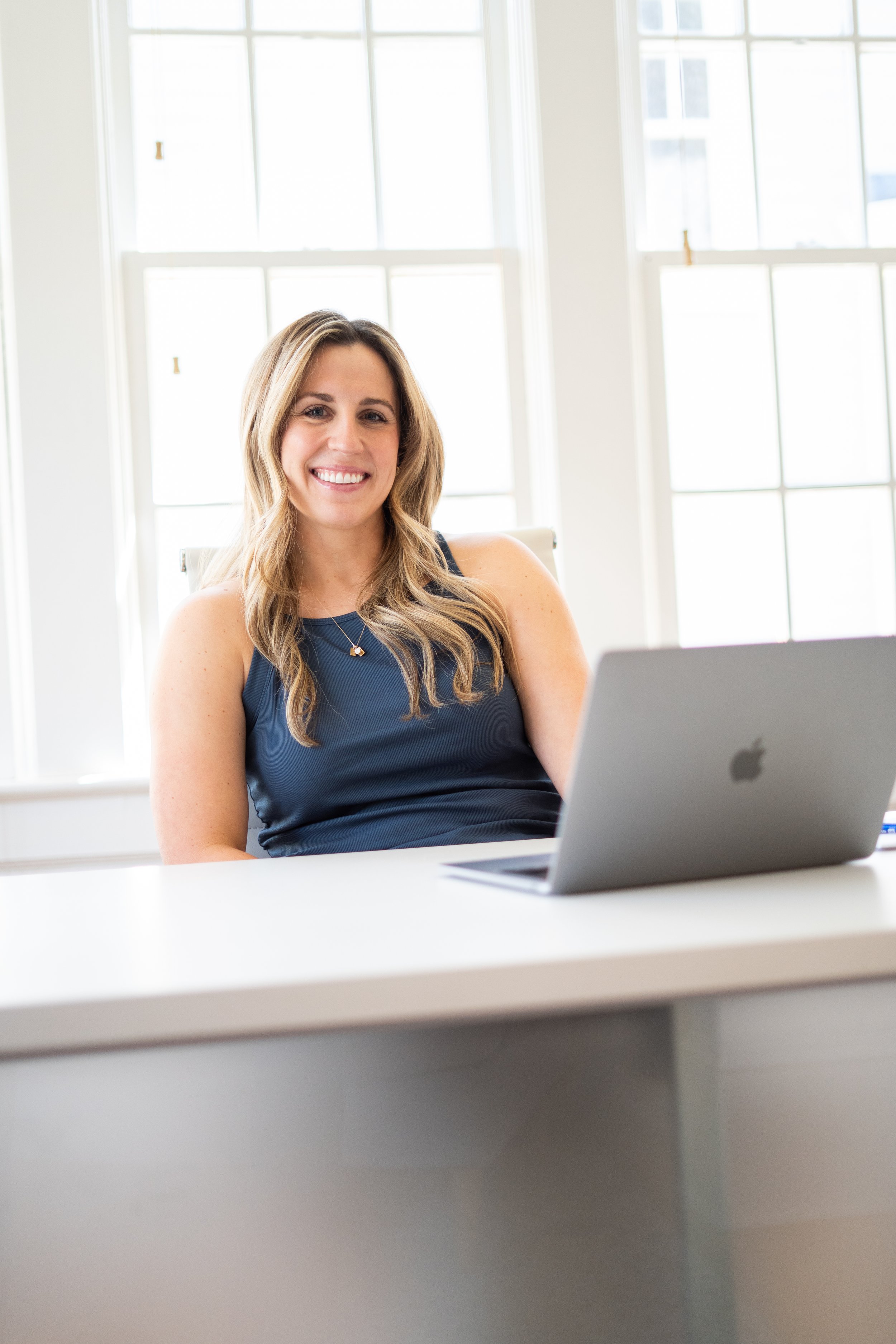 pelvic floor physical therapist sitting at desk doing a workshop