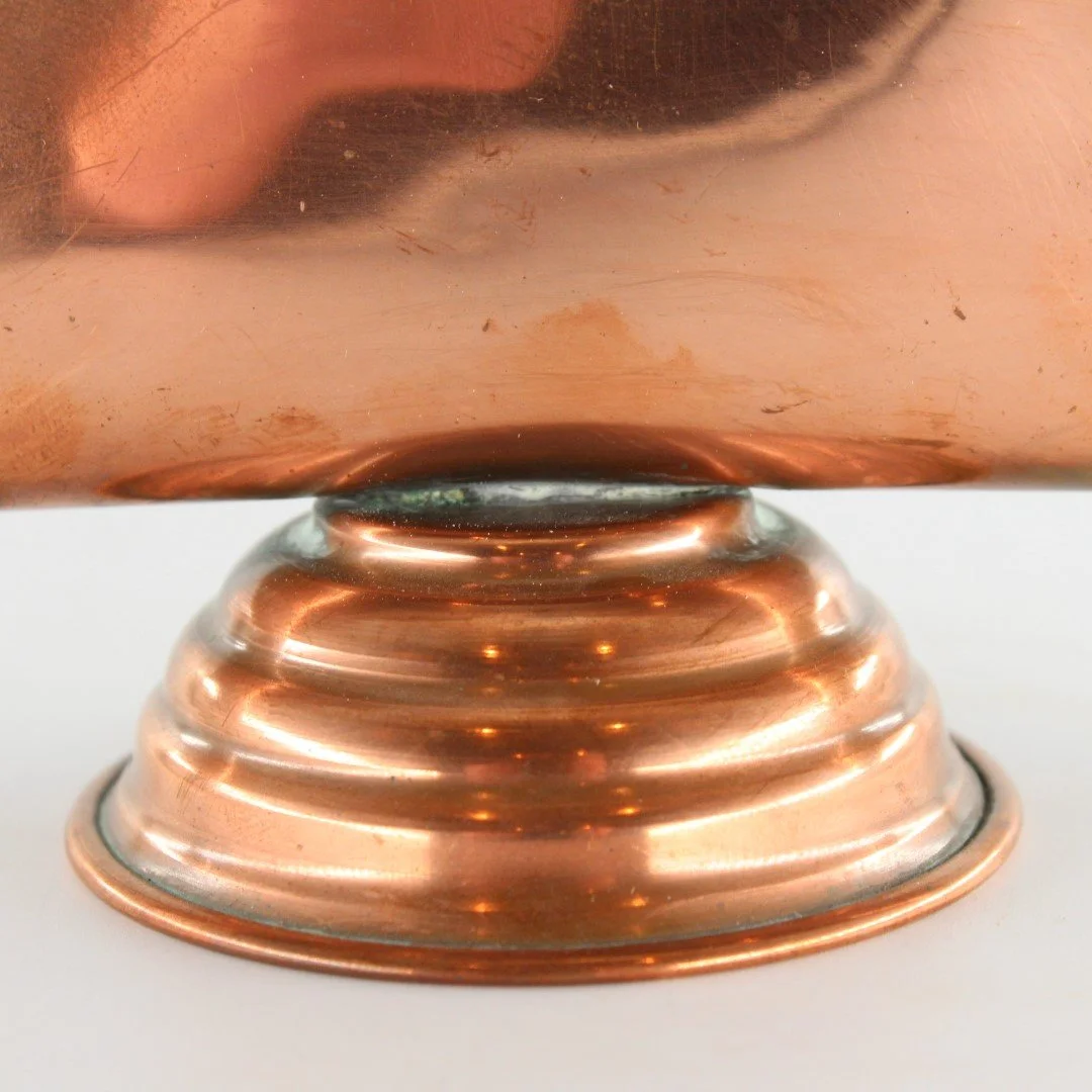 Vintage copper letter rack and mid century modern desk organiser with folded sculptural design and pedestal base against white background.