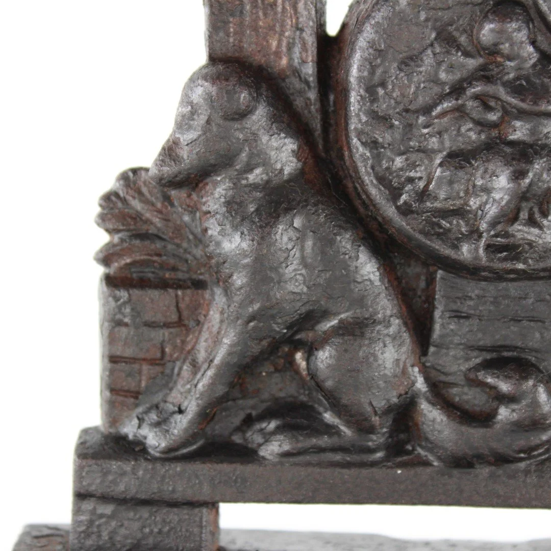Vintage cast iron figural doorstop depicting seated scholar with decorative relief base
