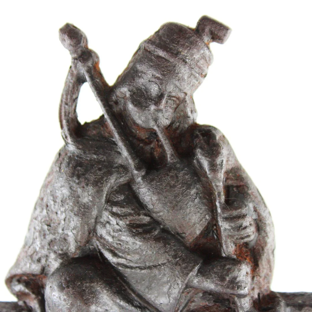 Antique Cast Iron Figural Doorstop – Seated Piper