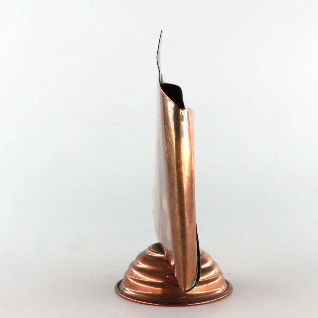 Vintage copper letter rack and mid century modern desk organiser with folded sculptural design and pedestal base against white background.