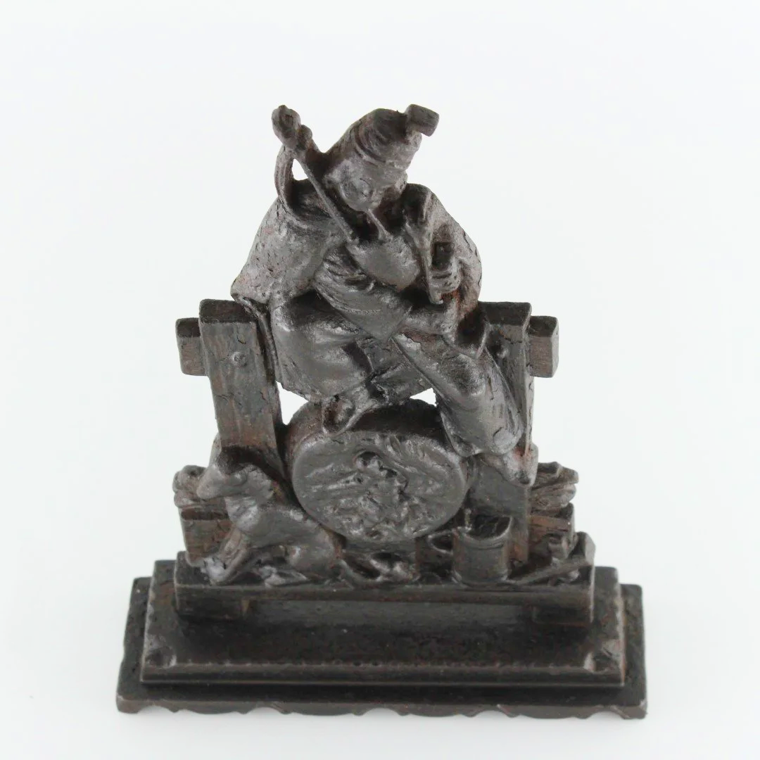 Antique Cast Iron Figural Doorstop – Seated Piper