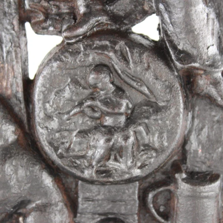 Vintage cast iron figural doorstop depicting seated scholar with decorative relief base