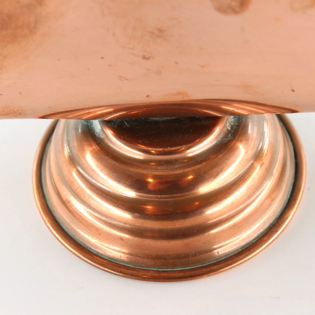 Vintage copper letter rack and mid century modern desk organiser with folded sculptural design and pedestal base against white background.