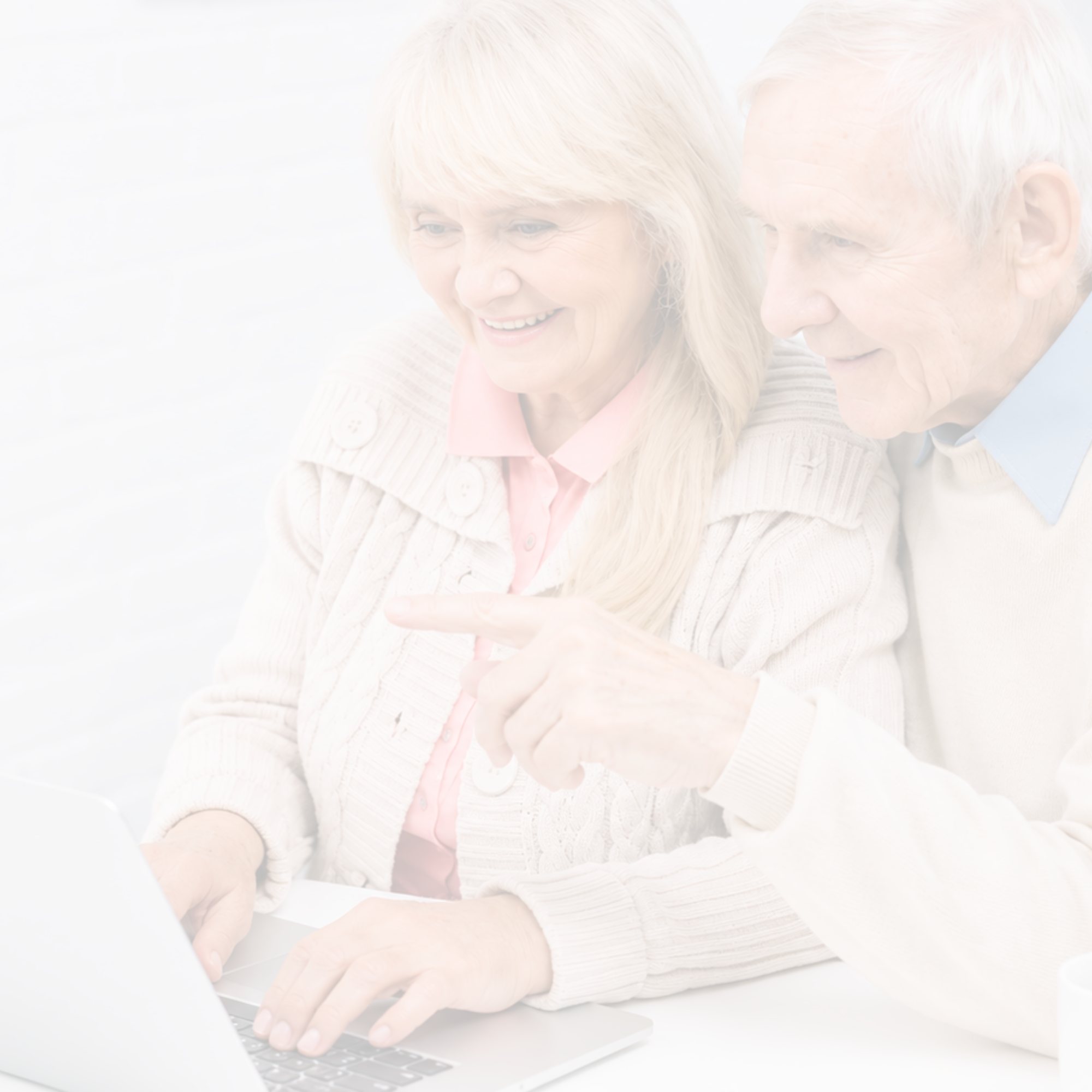 Older couple reviewing information together on a laptop at home