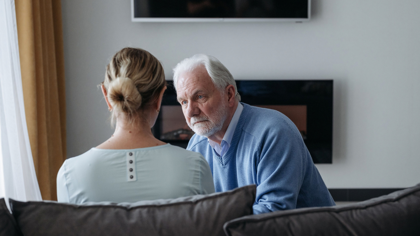 Older couple having a serious conversation at home