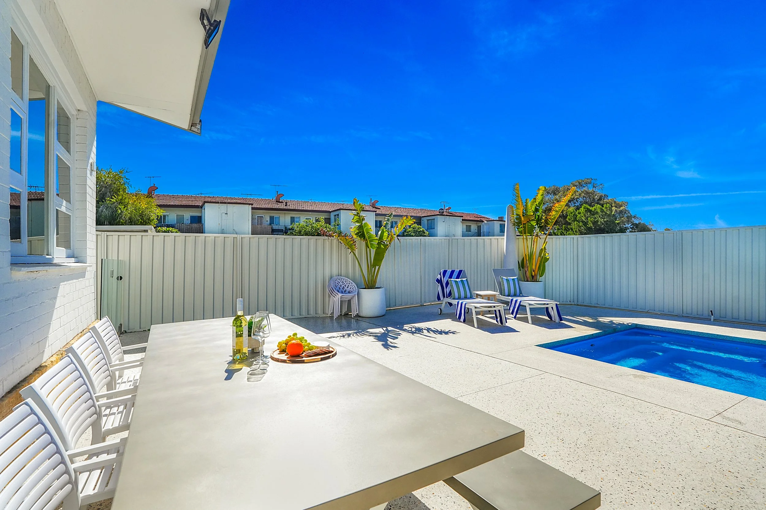 Pool patio area with dining table and chairs in Perth Australia