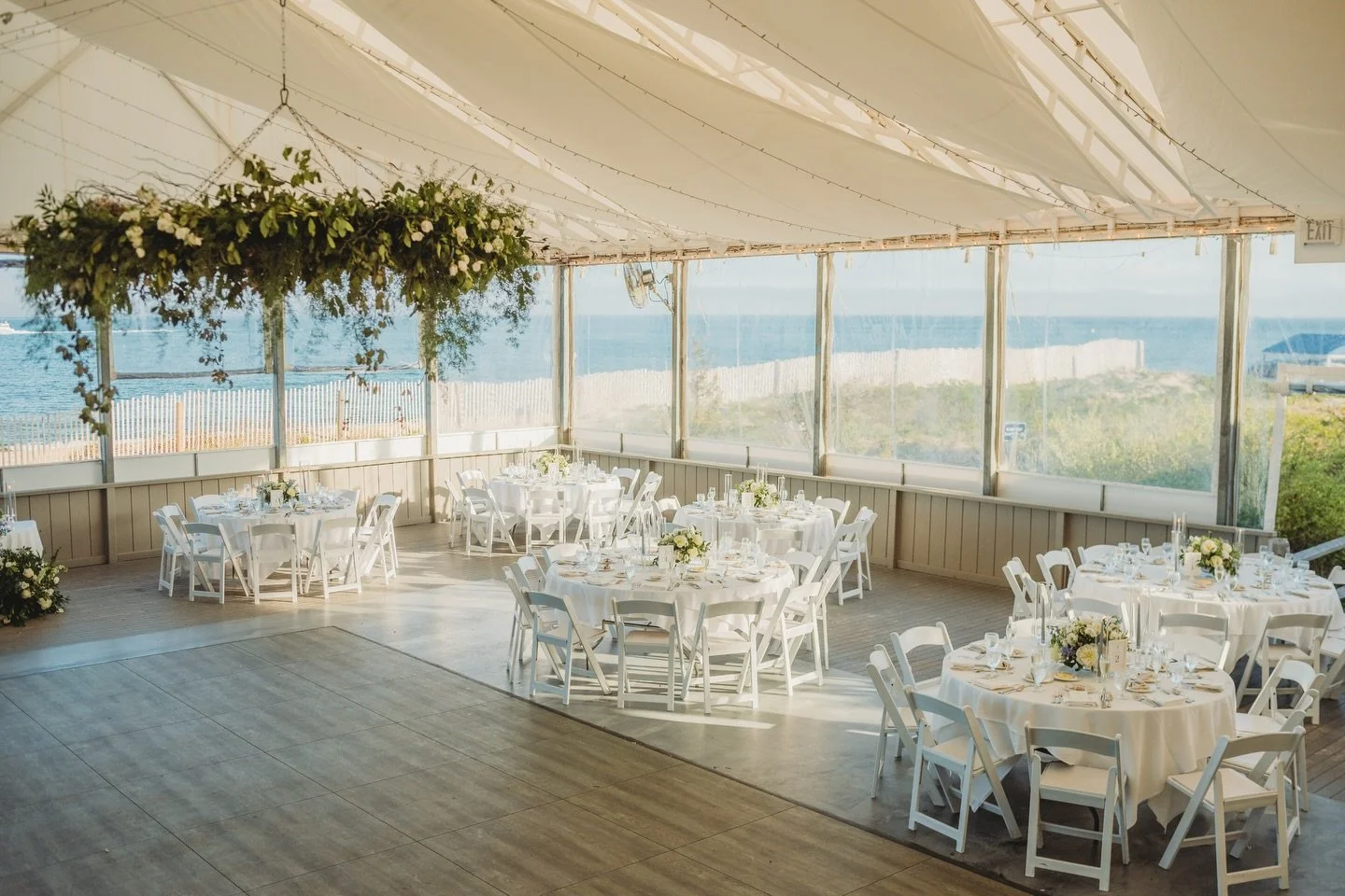 Designed to feel organic, overgrown, and a little unexpected, this hanging installation carried through every part of the design. From the ceremony florals to the sweetheart table and centerpieces, it was a focal point that brought the entire tent to