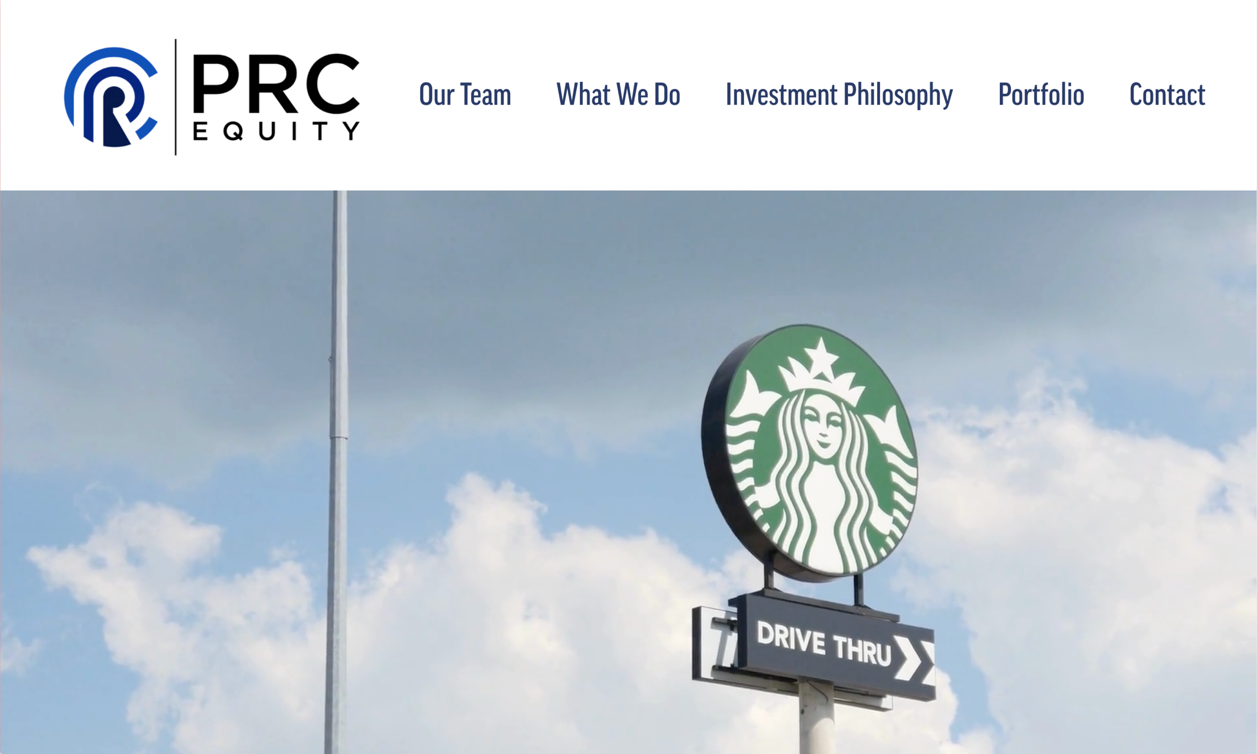 Starbucks logo with a drive-thru sign underneath against a blue sky with clouds.
