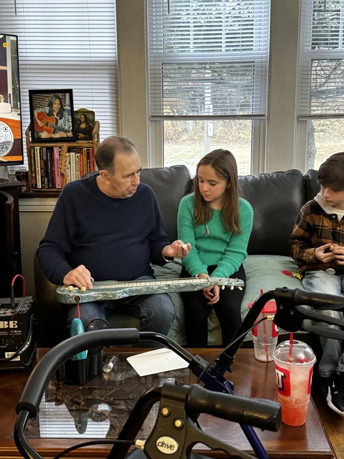 David Surkamp sharing music on acoustic guitar during a gathering.