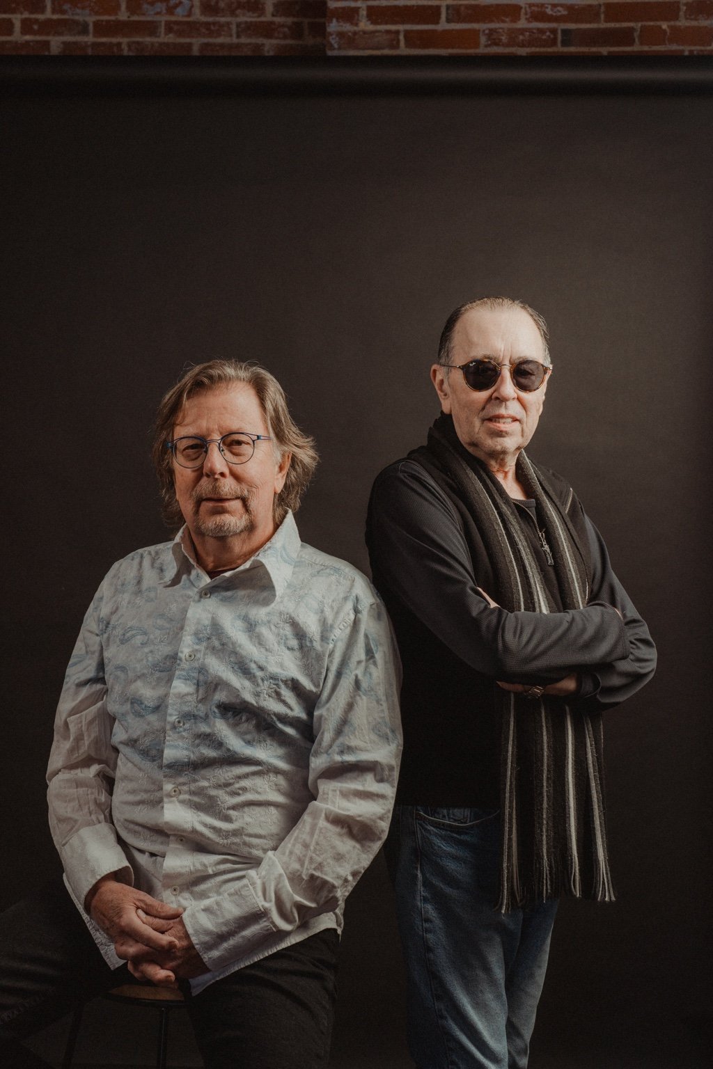 David Surkamp seated beside a companion for a portrait.
