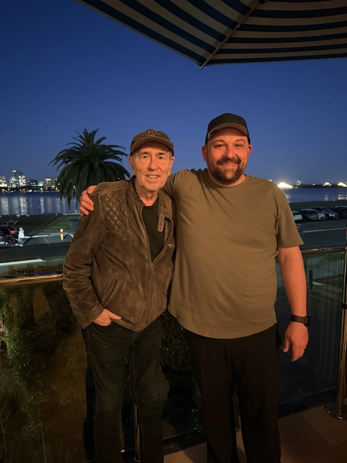 David Surkamp with a companion beside the water at dusk.