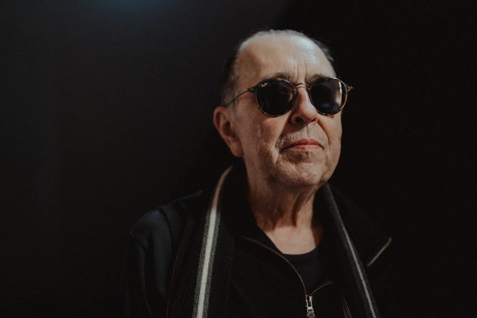 Portrait of David Surkamp wearing sunglasses.