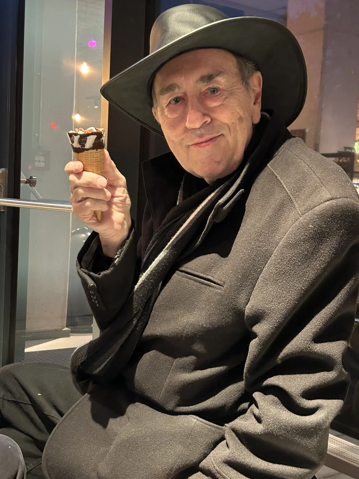 David Surkamp enjoying an ice cream in his wide-brimmed hat.