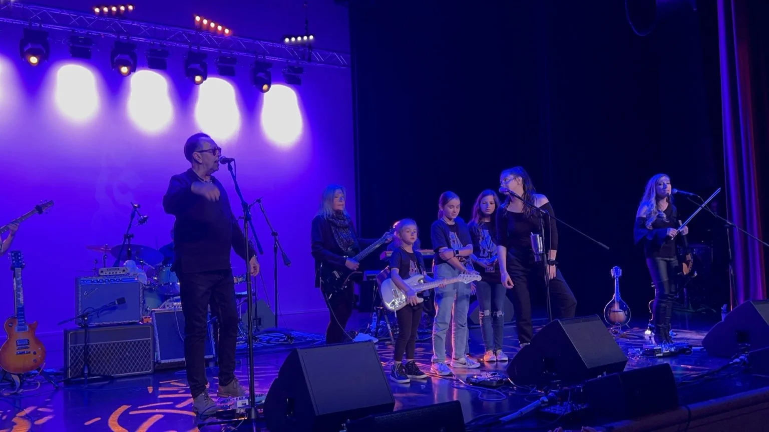 Pavlov’s Dog performing under purple stage lights.