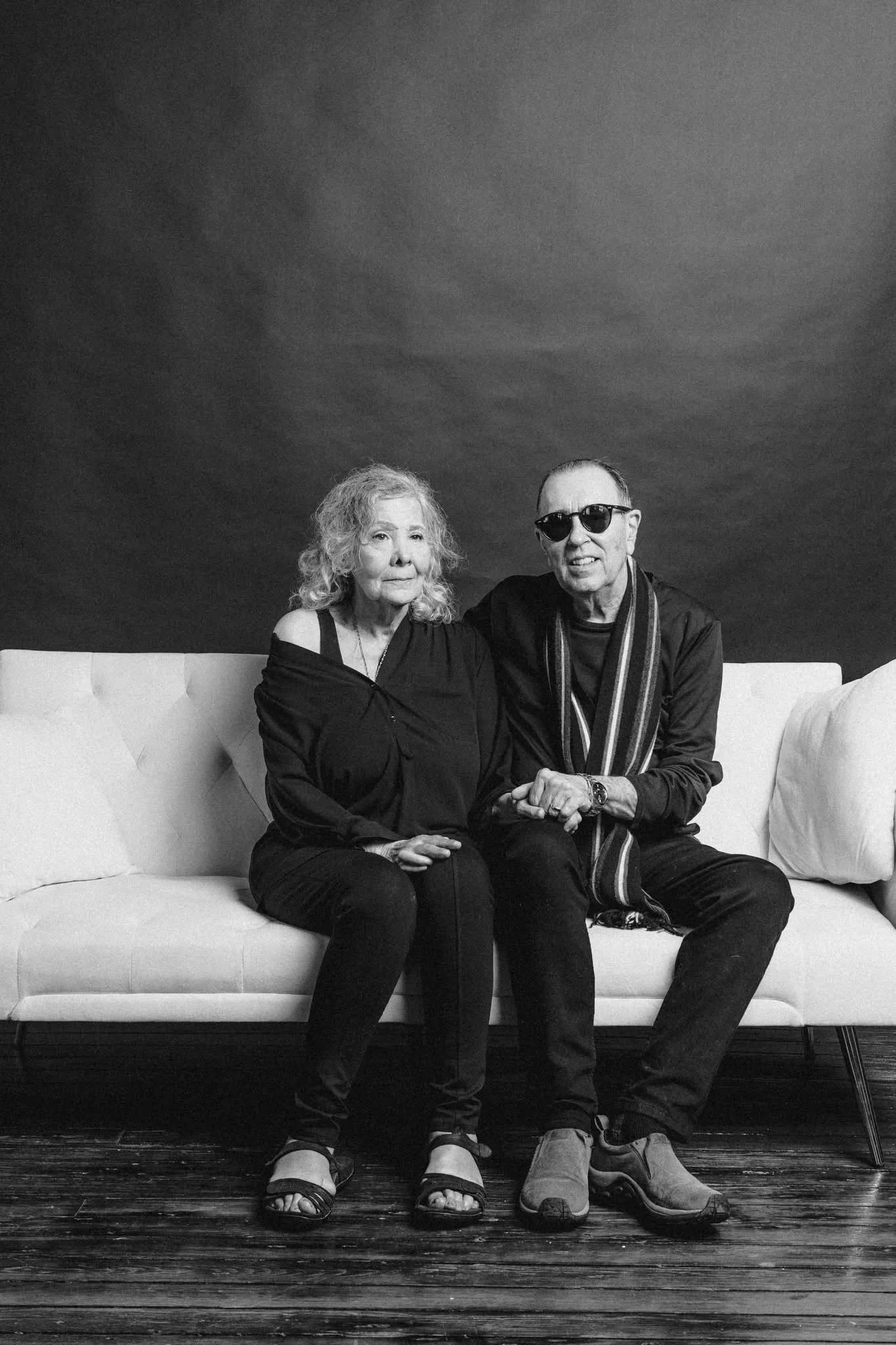 David Surkamp seated with a companion in a black-and-white portrait.