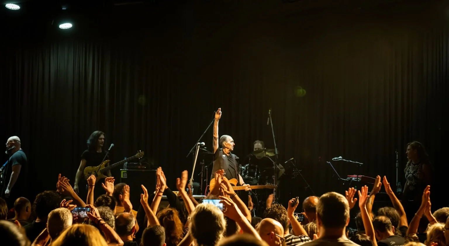 An enthusiastic crowd reaching toward the stage at a Pavlov’s Dog concert.