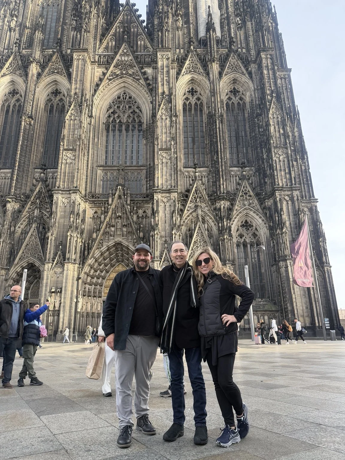 David Surkamp with companions outside a Gothic cathedral.