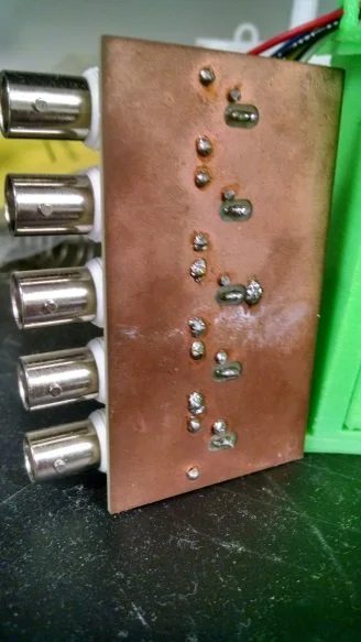 PCB on the back of the rig with BNC jacks for connected the rig directly to electrophysiology equipment.