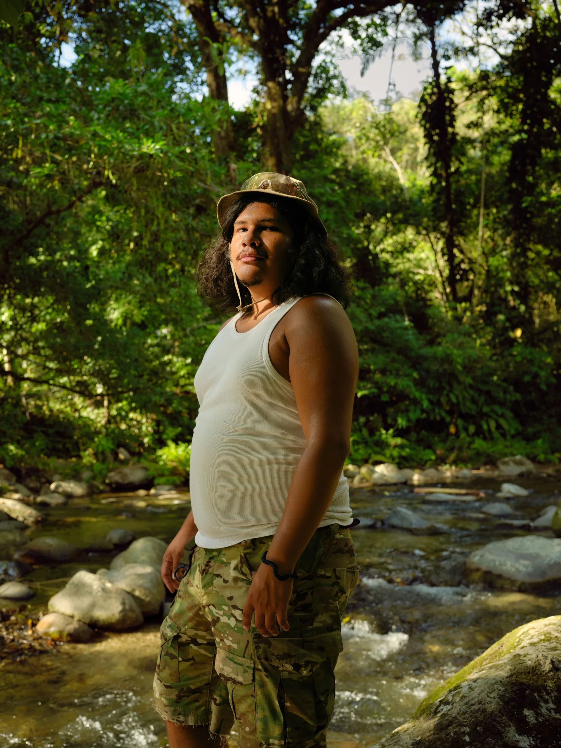 portrait of man in camouflage with a river in background