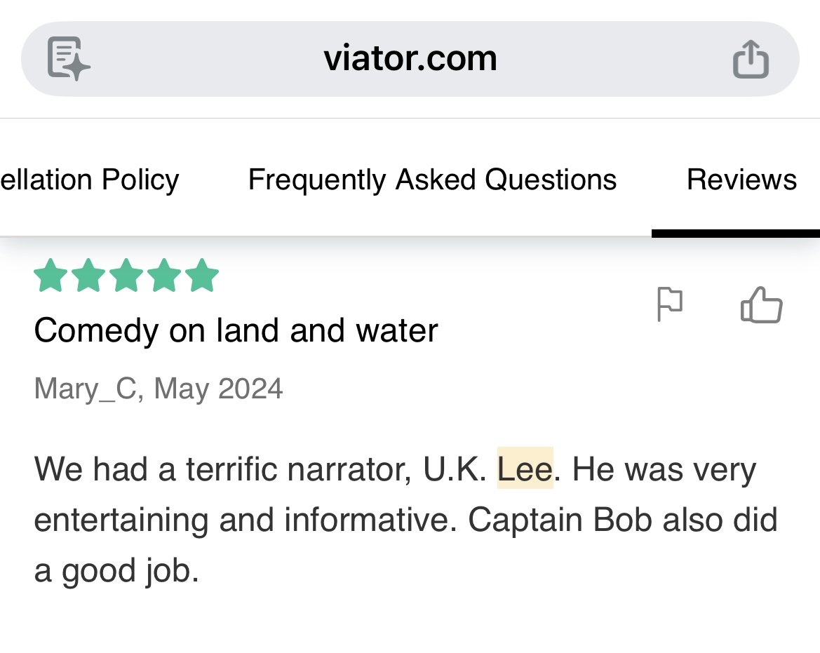 Screenshot of a review page from viator.com with a 5-star rating and a review titled "Comedy on land and water" by Mary_C from May 2024. The review mentions a narrator named Lee from the UK, and the reviewer compliments the entertainment and captain Bob.