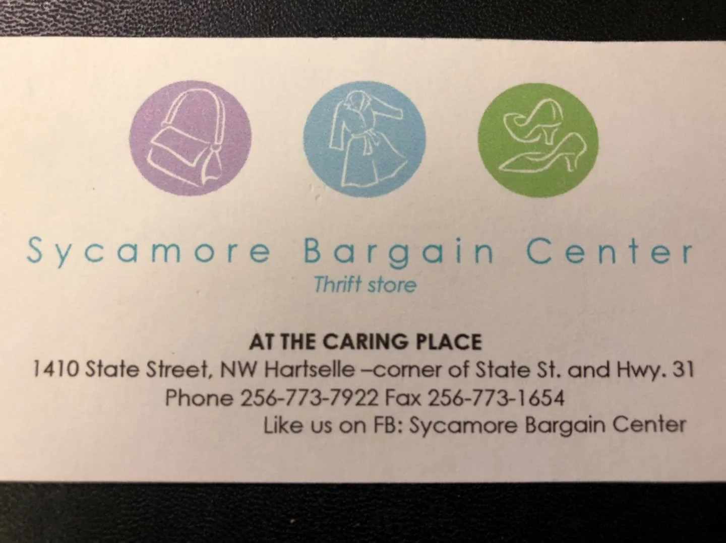 Business card for Sycamore Bargain Center thrift store with icons of a handbag, a person shopping, and a pair of high-heeled shoes