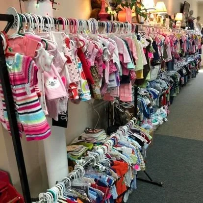 Kids' clothing on display racks at a thrift store or resale shop.
