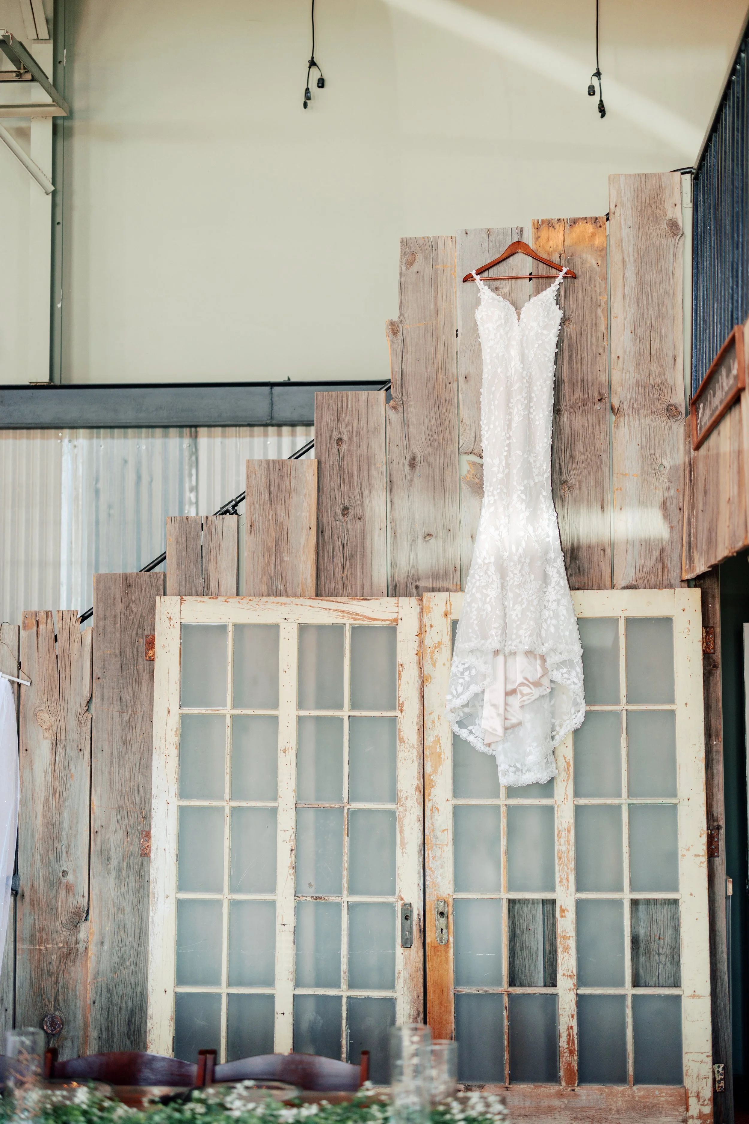 Bride's wedding dress hanging from venue for photographer to capture