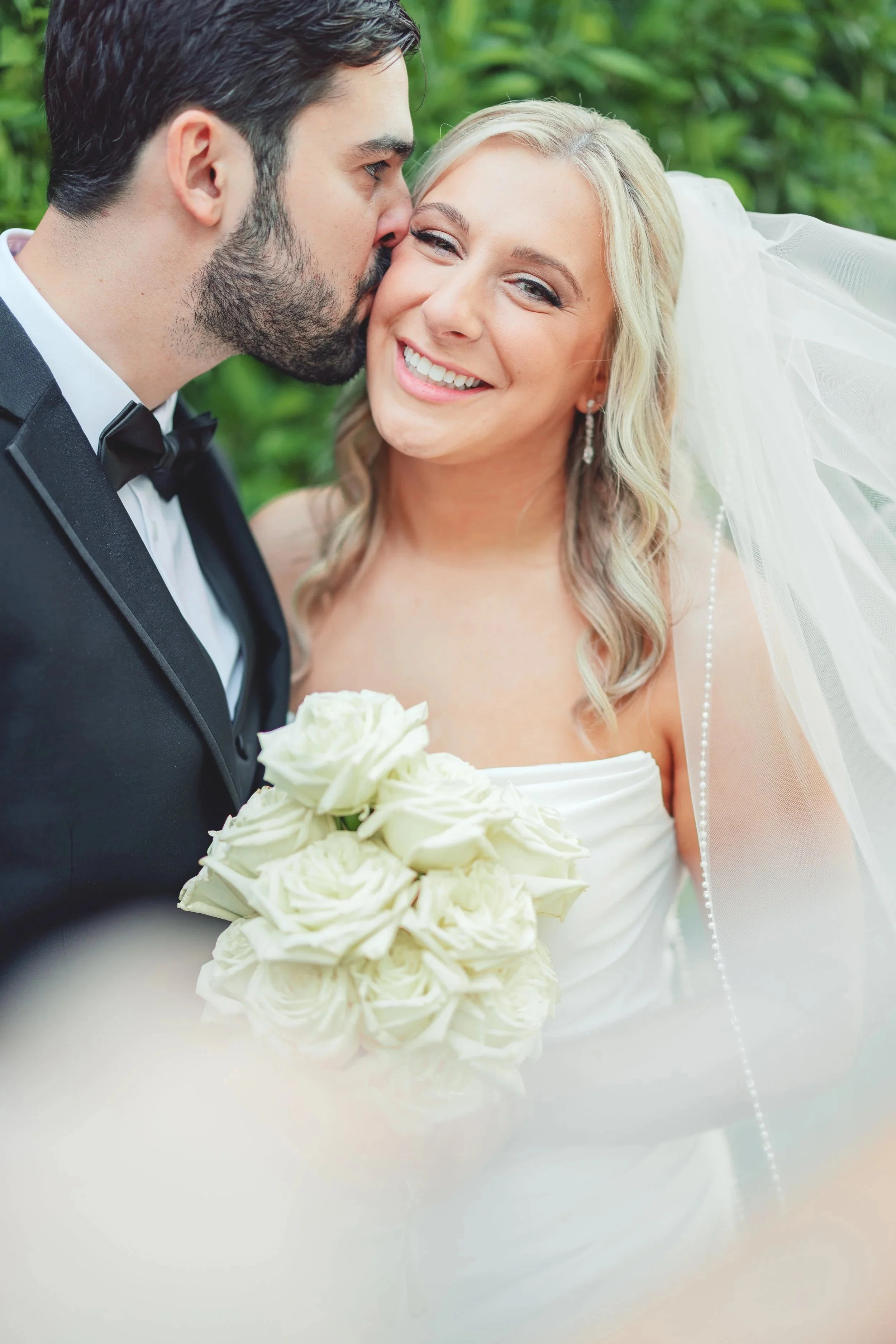 Bride smiles at wedding photographer while