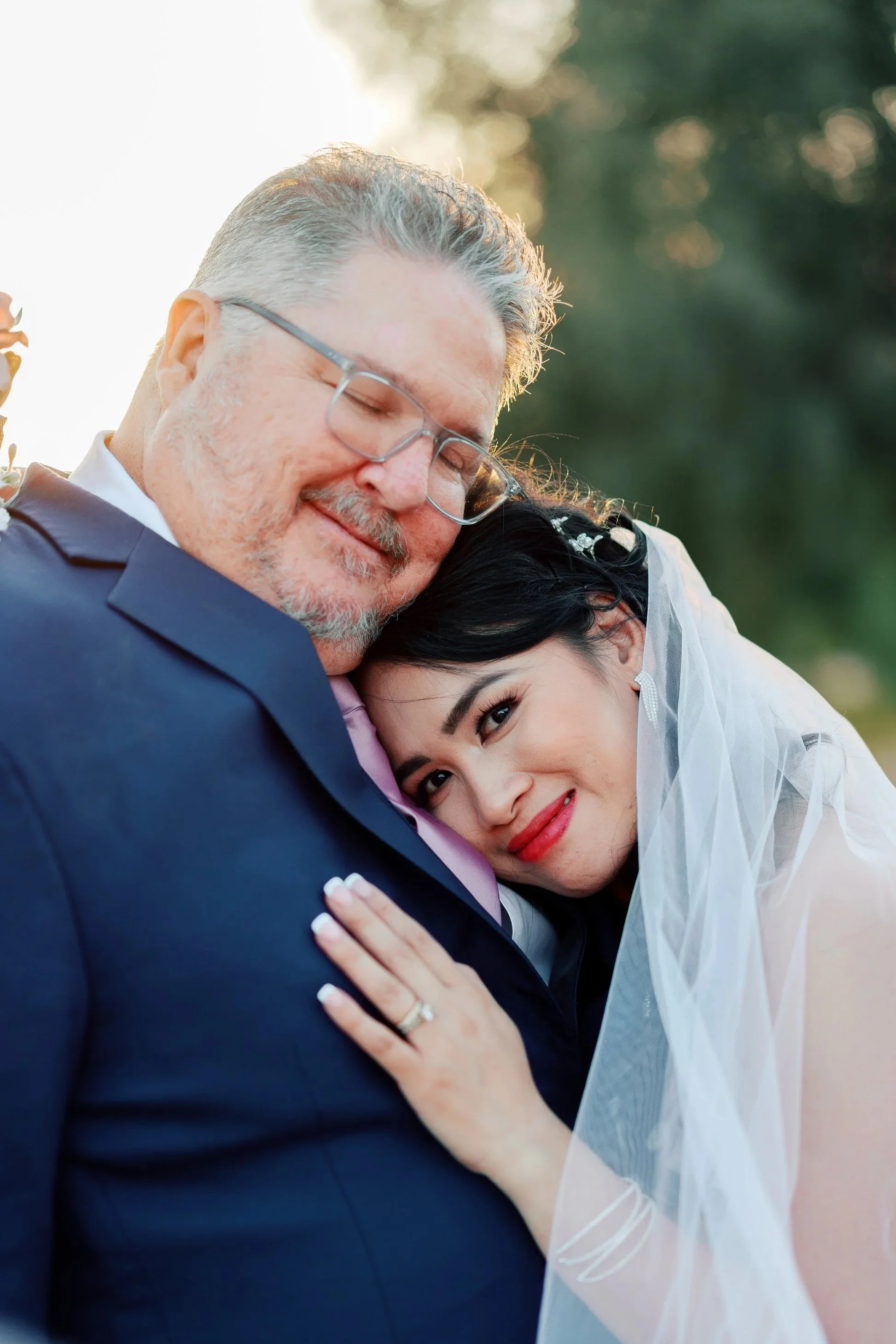 Wedding portrait of Corey and Maria posing in front of photographer