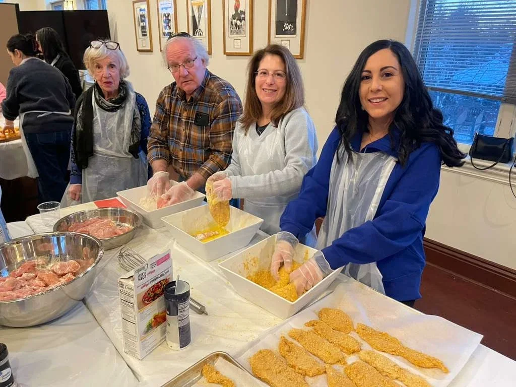 Volunteers cooking at Kitchen of Kindness