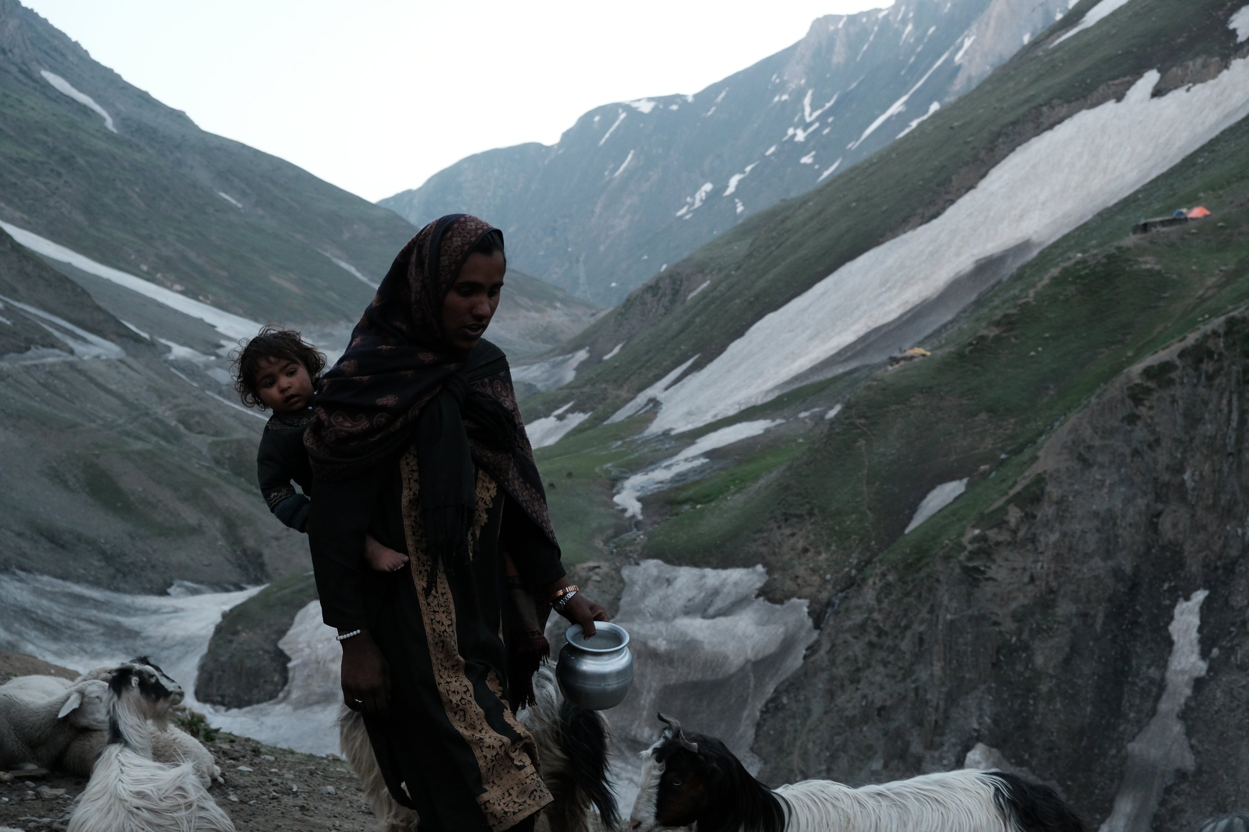 Mother and child in the high mountains of the Himalayas, where they move from one place to the next with their herd of sheep and goats