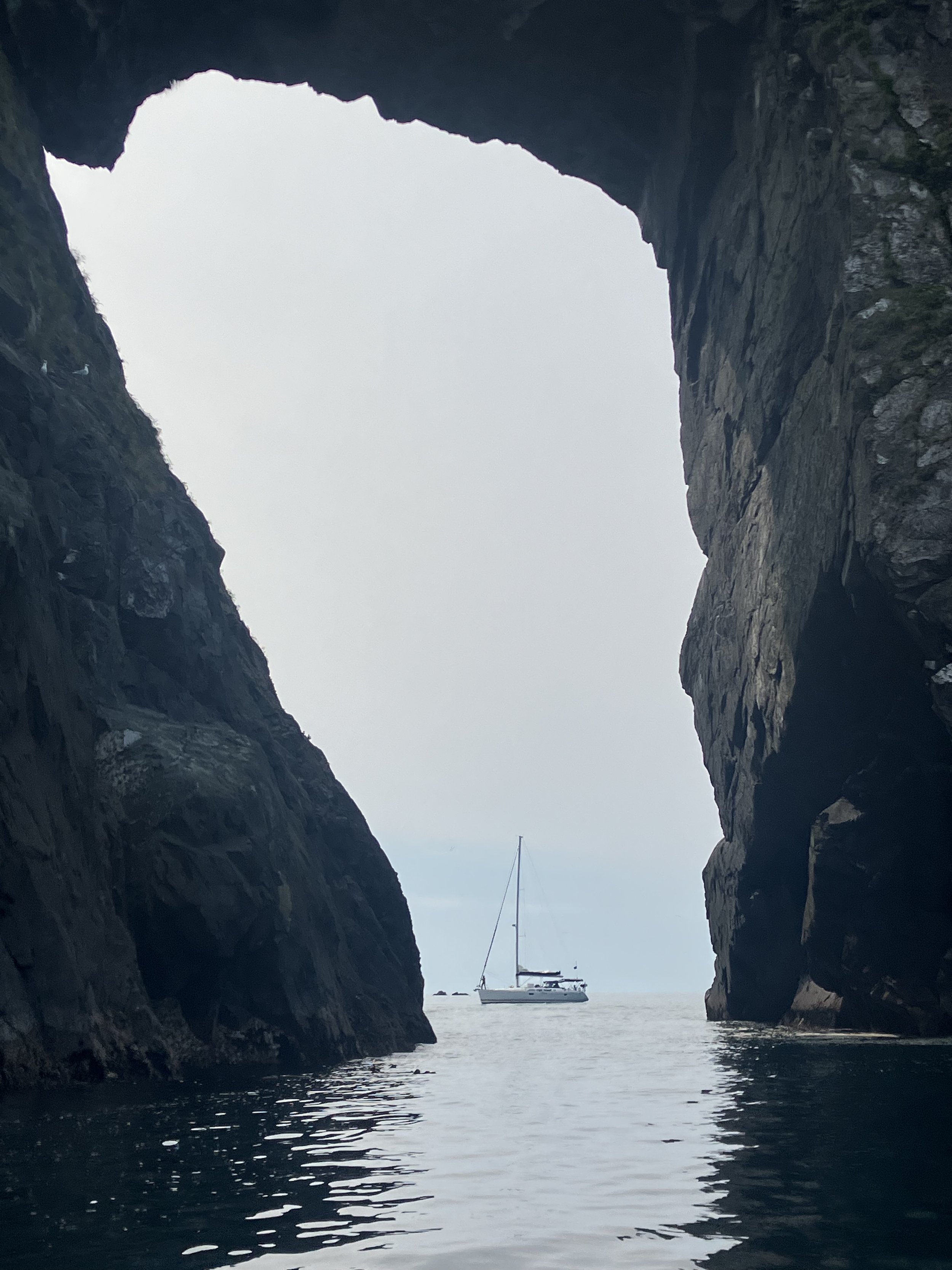 Sailboat seen through a giant arch