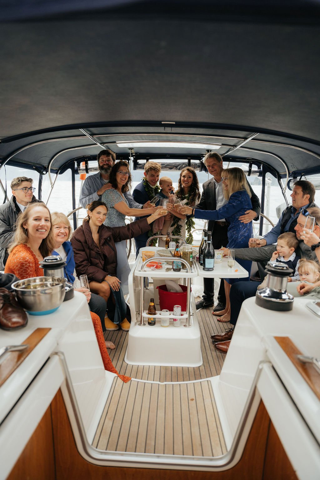 Group of people celebrating on a boat with drinks