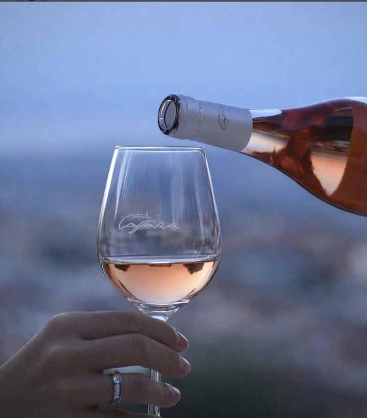 Rosé wine being poured into a tasting glass
