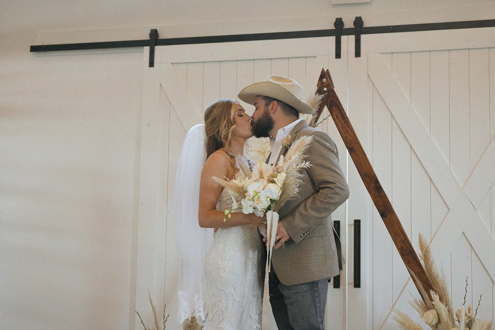 western wedding bride and groom first kiss