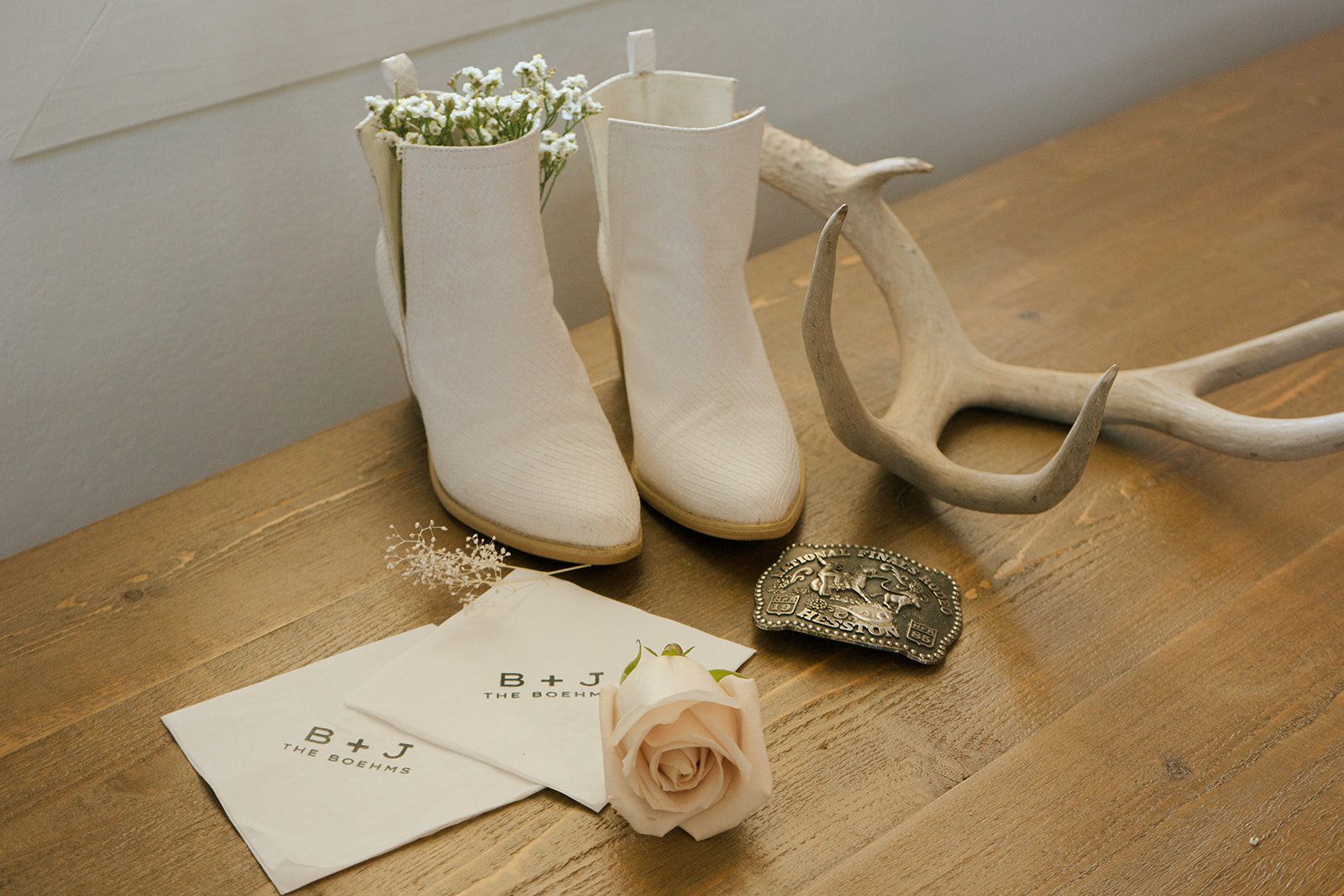white boots and wildflower photo at western wedding