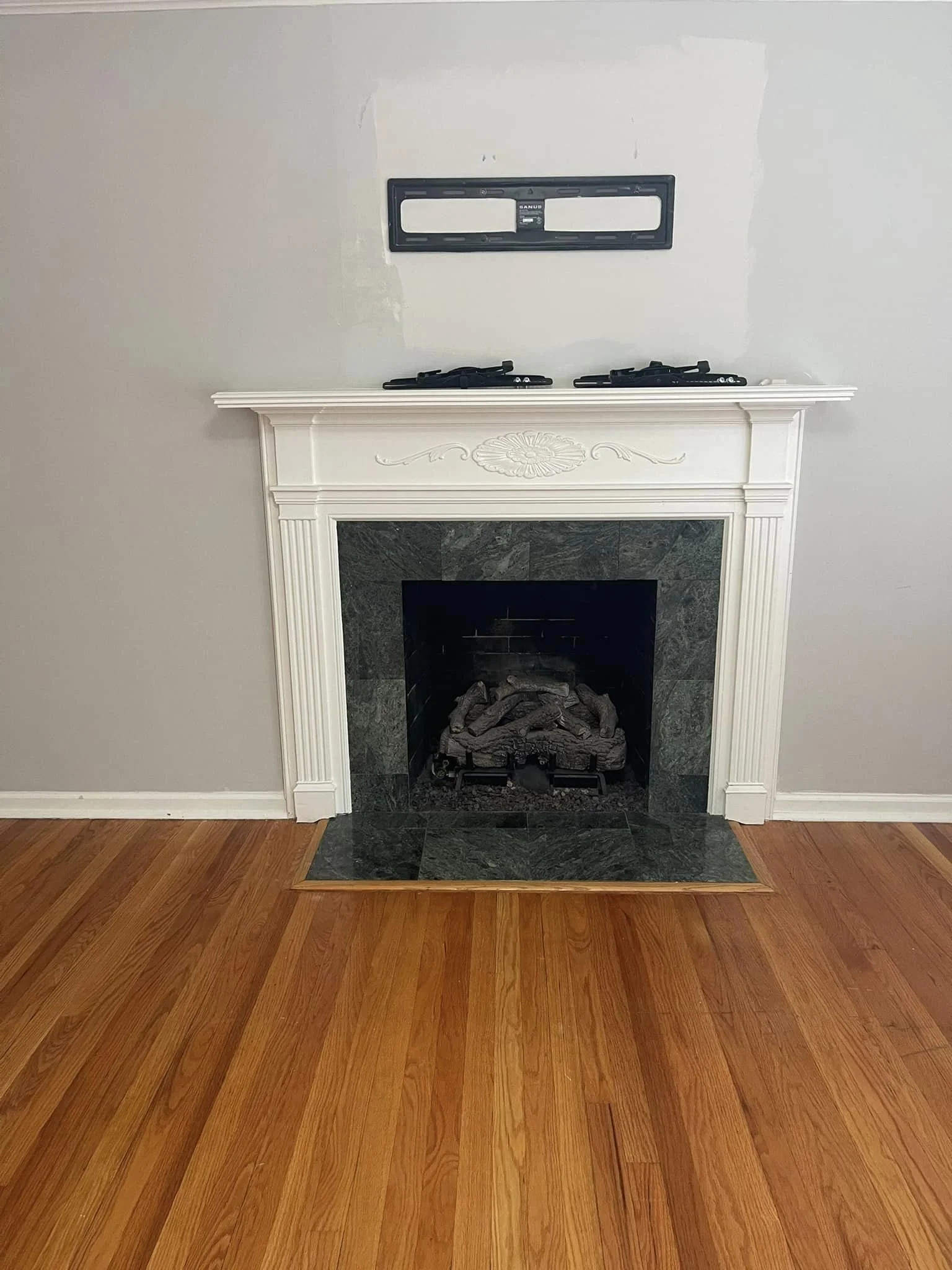 Fireplace before the makeover- Tiles needed a major update so i found help on pinterest for how to paint fireplace tiles. 