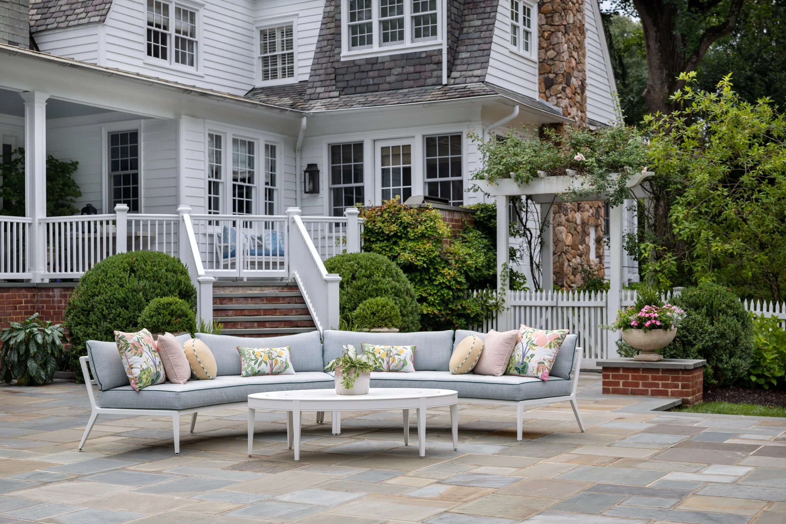Custom curved outdoor sectional seating area in traditional home setting.
