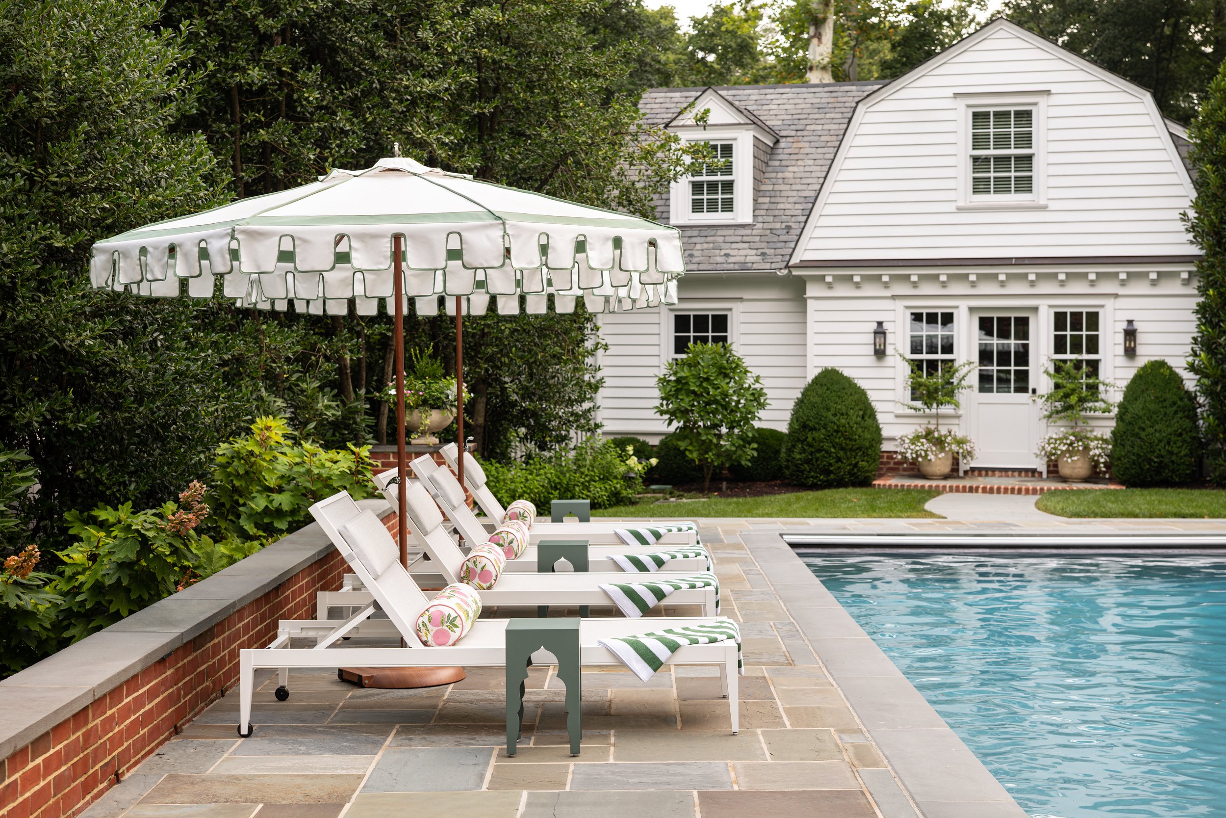 Residential pool with resort feel and custom chaises and umbrellas.