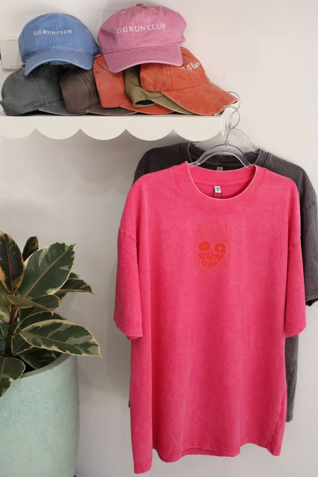 O.G Run Club caps and pink washed tee hanging in O.G Bowls Gosford
