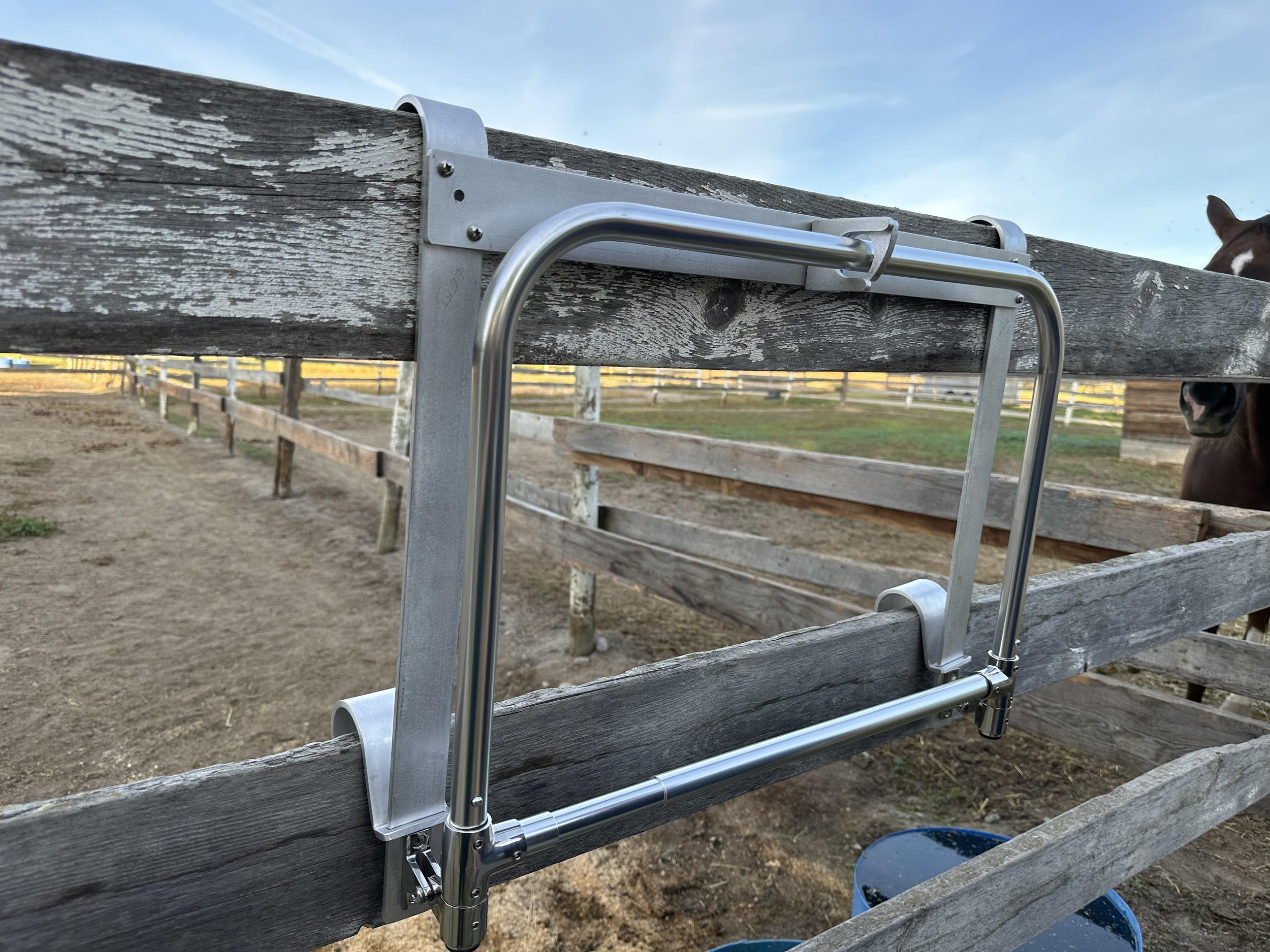 HayPal-Portable-Drop-Down-Feeder-on-a-fence.jpg