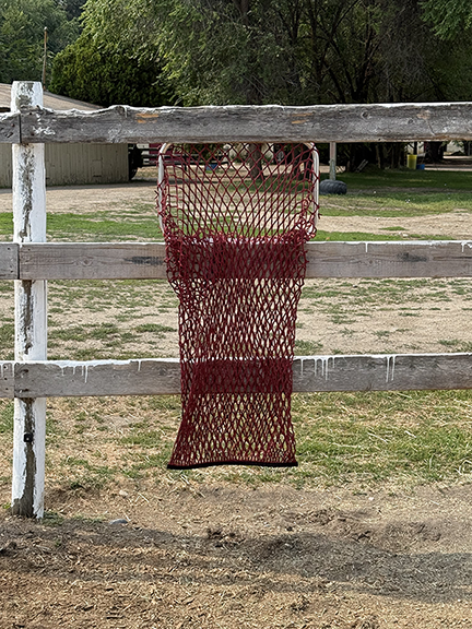 HayPal-Universal-Slow-Feeder-flat-bottom-hay-net-from-horse-side-of-the-fence - Copy.png
