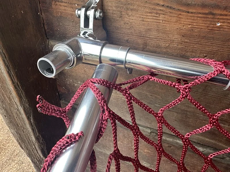 Installing-a-slow-feed-hay-net-onto-HayPal-Drop-Down-Feeder.jpg