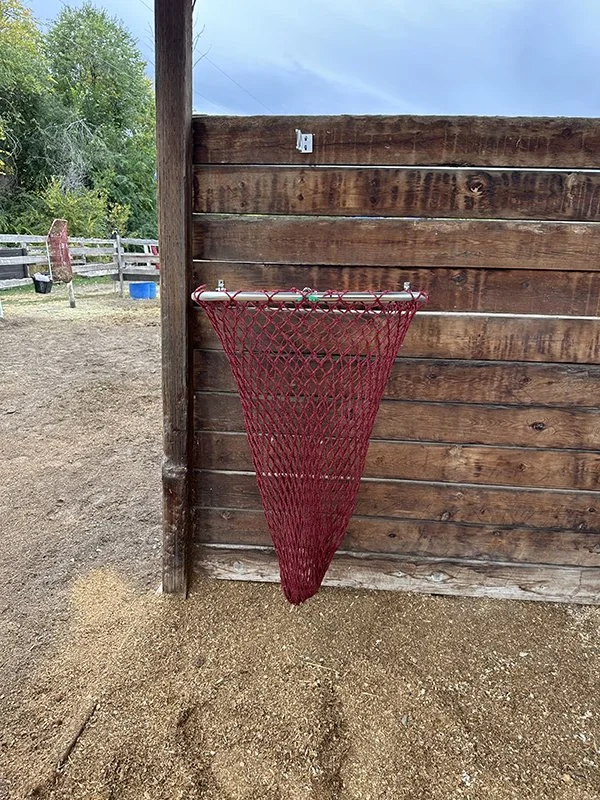 HayPal-Drop-Down-Feeder-outside-on-a-shelter-wall.jpg